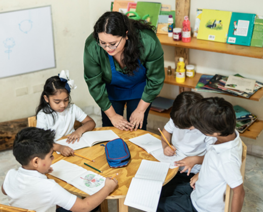 Image of a teacher with her young students.